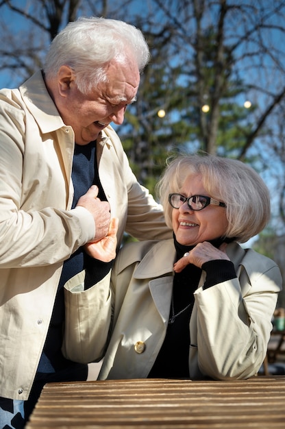 Smiley senior people outdoors medium shot