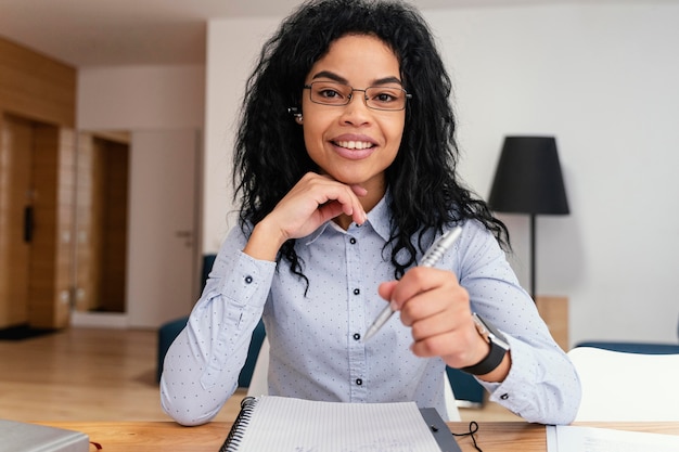 Smiley teenage girl at home during online school