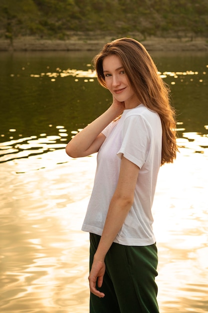 Smiley woman by the lake side view