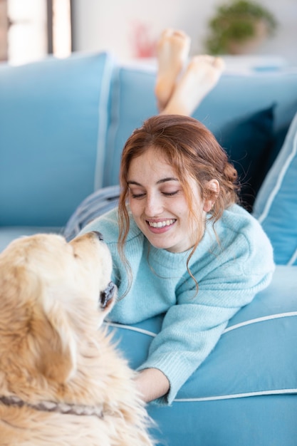 Smiley woman on couch with dog