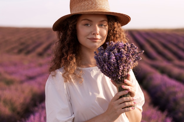 Smiley woman holding lavender medium shot