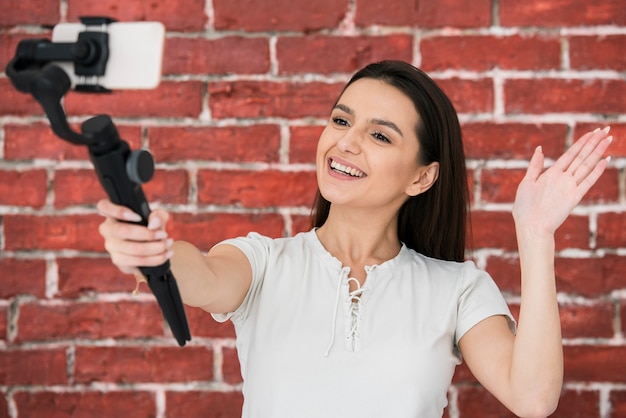 Smiley woman recording a video