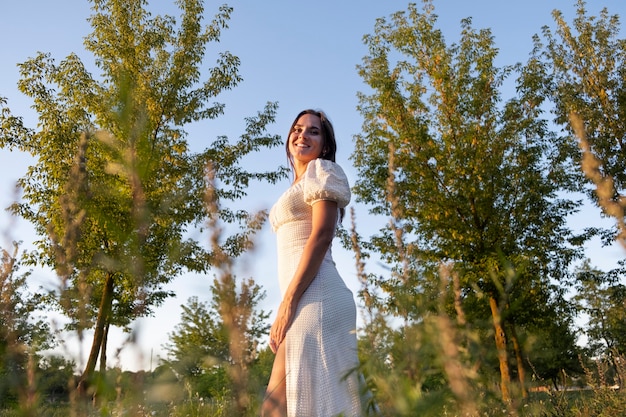 Smiley woman relaxing in nature low angle