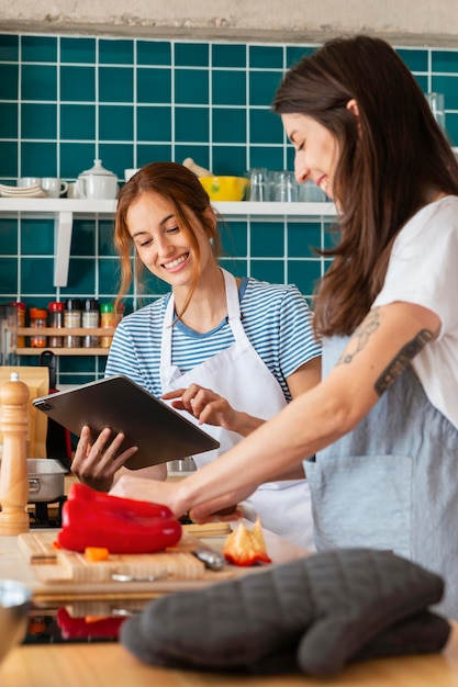 Smiley women in kitchen medium shot