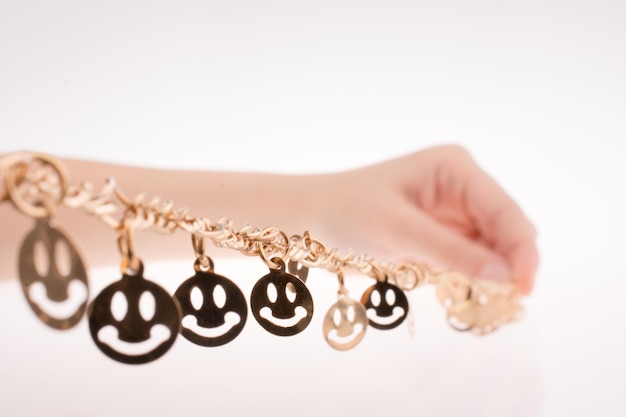 Smileys on a chain in hand