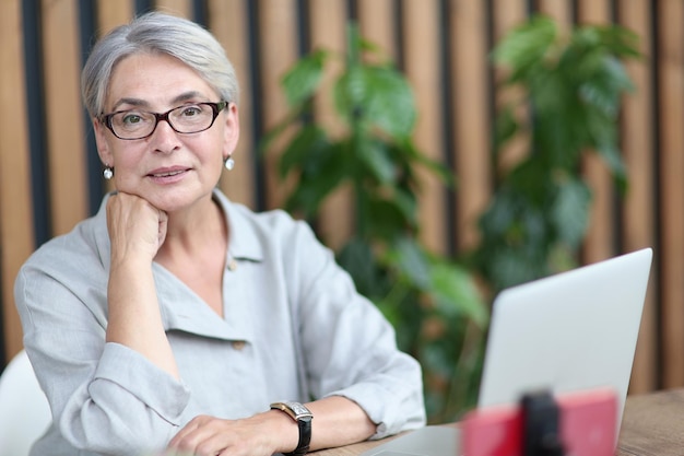 Smiling 60yearold business lady using a computer