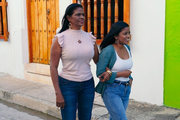 Smiling African woman walking with her mother