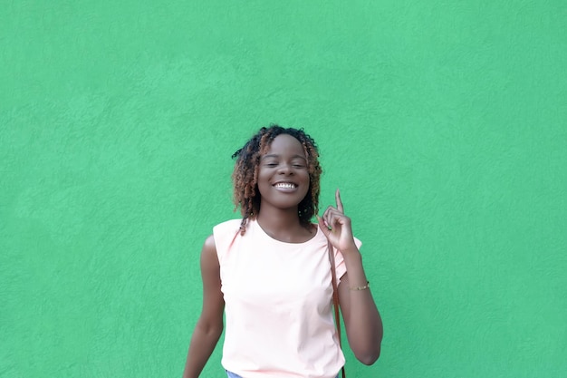 A smiling AfricanAmerican woman on a green background Beautiful people Copy space