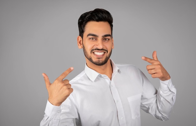 Smiling Arab Businessman Pointing Finger At Himelf And Looking At Camera