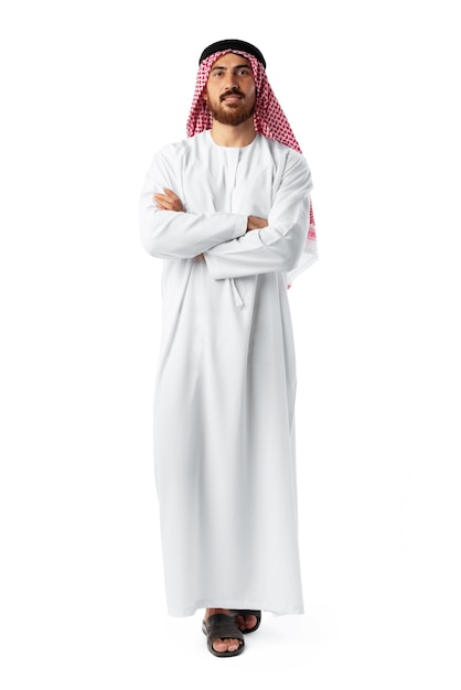 Smiling arab man while standing in an isolated white studio