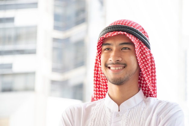 Smiling Arabian man is on blurry background