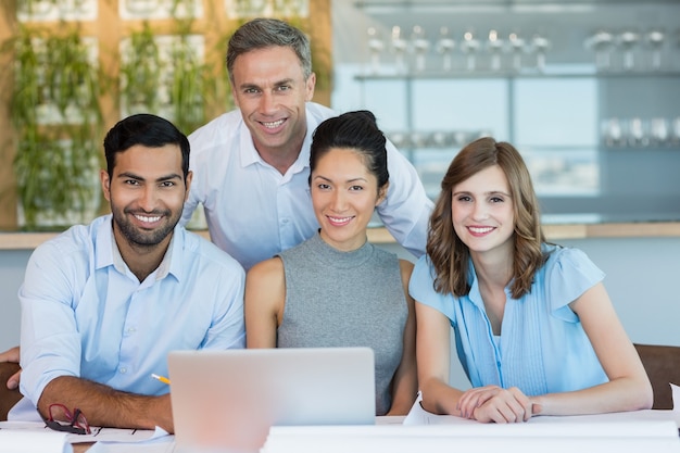 Smiling architects sitting together in office