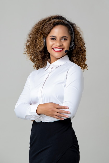 Smiling arms crossed African American woman wearing microphone