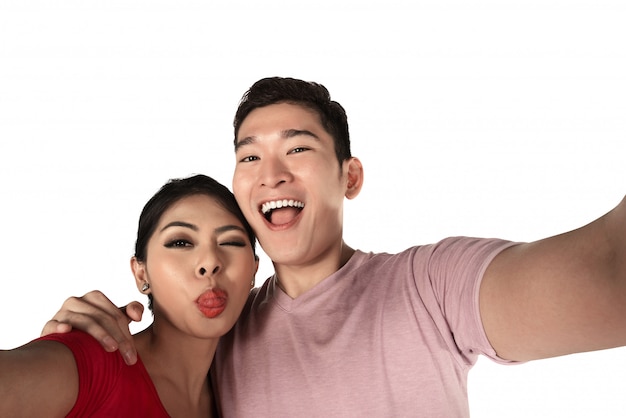 Smiling asian couple taking a selfie