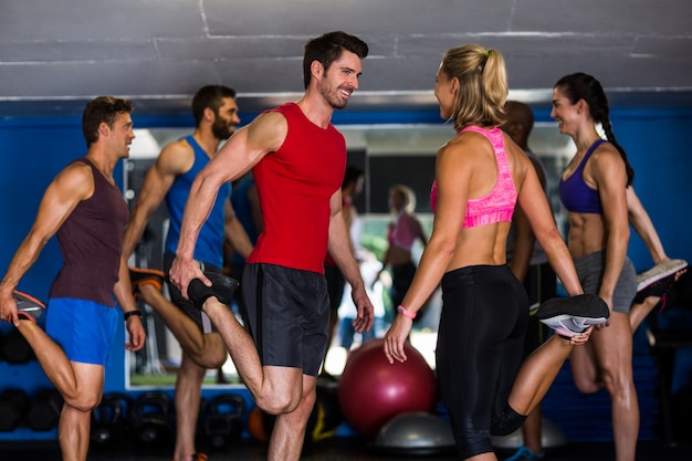 Smiling athletes standing on one leg