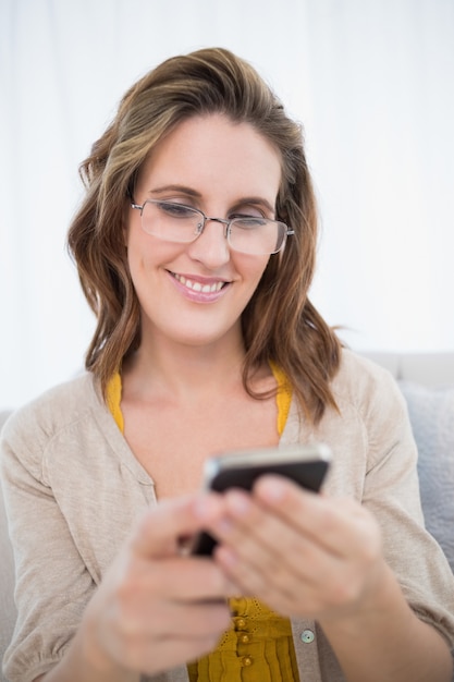 Smiling attractive woman wearing glasses using phone