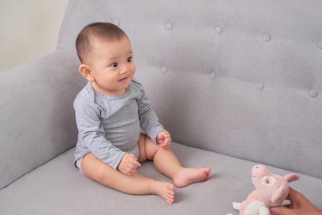 Smiling baby girl toddler in white bodysuit