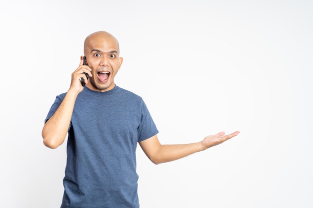 Smiling bald man with serving something while making a call