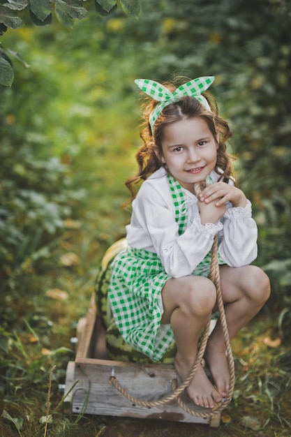 Smiling barefoot girl with a cart of watermelons 1926