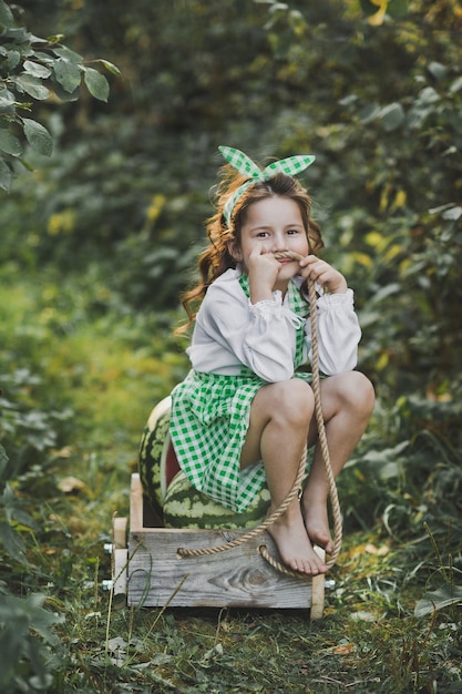 Smiling barefoot girl with a cart of watermelons 1927