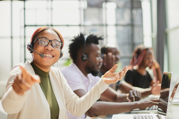 Smiling beautiful African American woman working in call center with diverse team