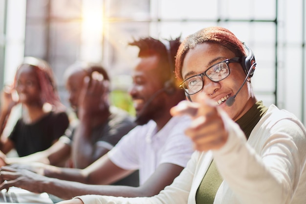 Smiling beautiful african american woman working in call center with diverse team