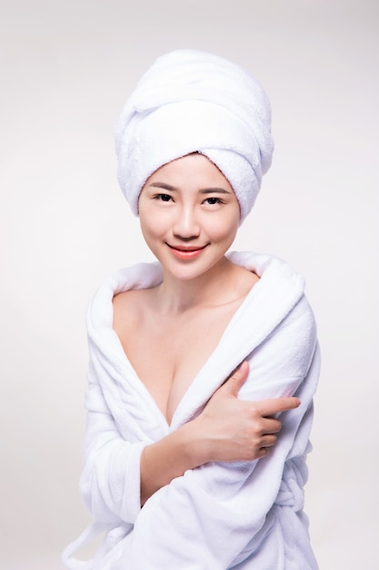 smiling and beautiful asian woman wearing bathrobe