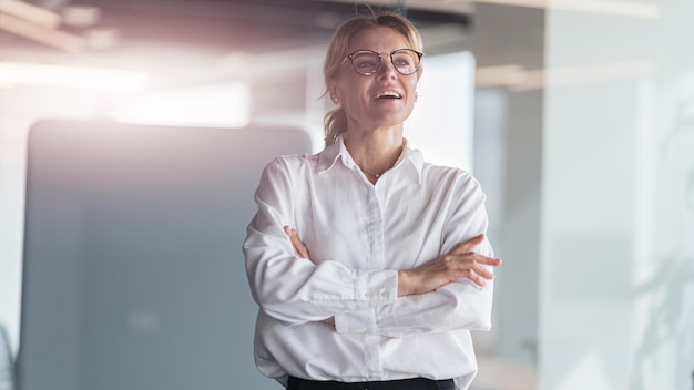 Smiling beautiful business woman working in modern it office and looks away