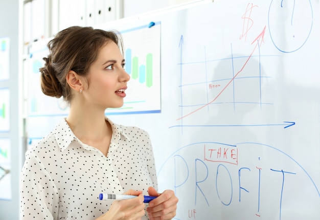 Smiling beautiful woman in office telling something important