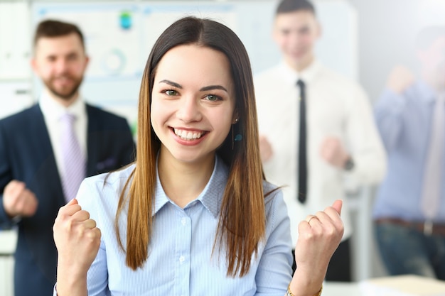 Smiling beauty businesswoman office portrait standing on group business peoples background. Demonstrates joy winning end reporting period education completion affairs and energy concept