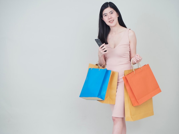 Smiling beauty woman with colorful shopping bags