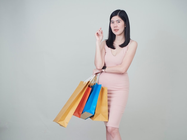 Smiling beauty woman with colorful shopping bags