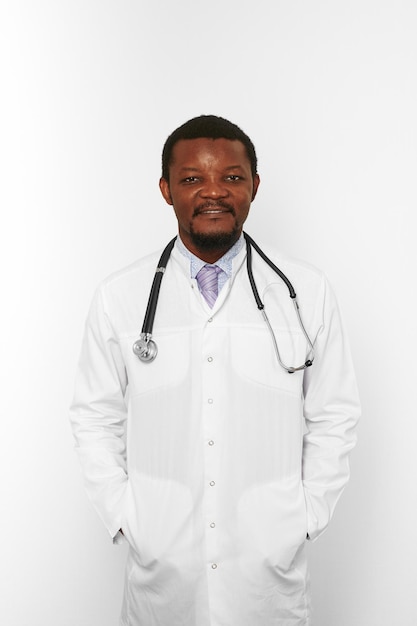 Smiling black bearded doctor man in white coat with stethoscope isolated on white background