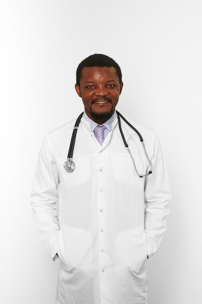 Smiling black bearded doctor man in white coat with stethoscope isolated on white background