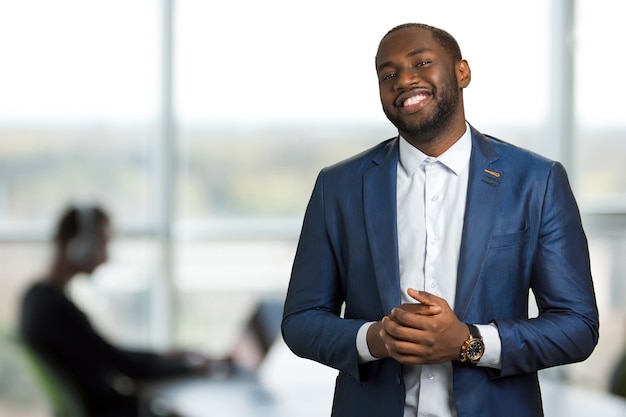 Smiling black businessman in office. american man in suit in good mood