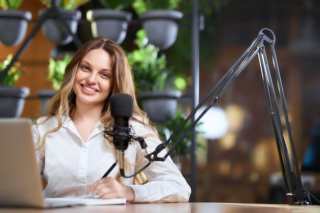 Smiling blogger woman recording new video for followers