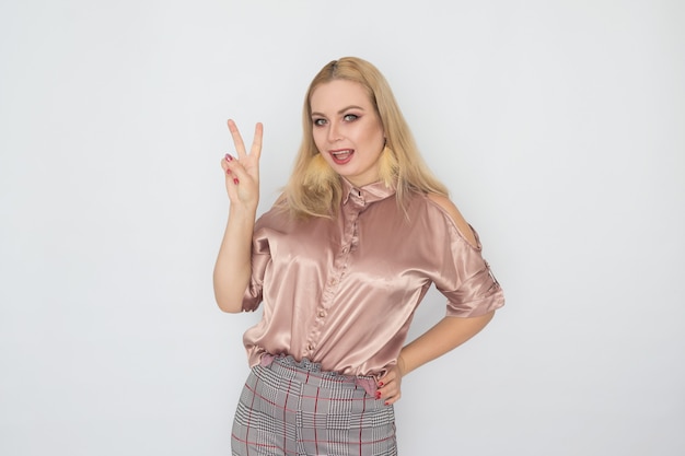 Smiling blonde business woman in pink blouse over white background