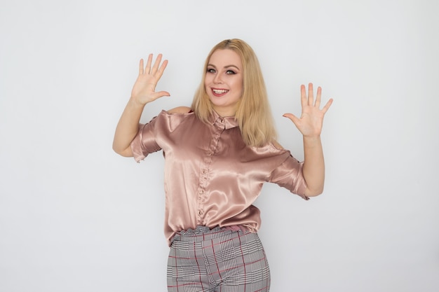 Smiling blonde business woman in pink blouse over white background