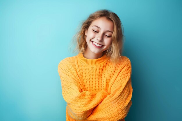 Photo a smiling blonde woman wearing a yellow sweater with her arms crossed