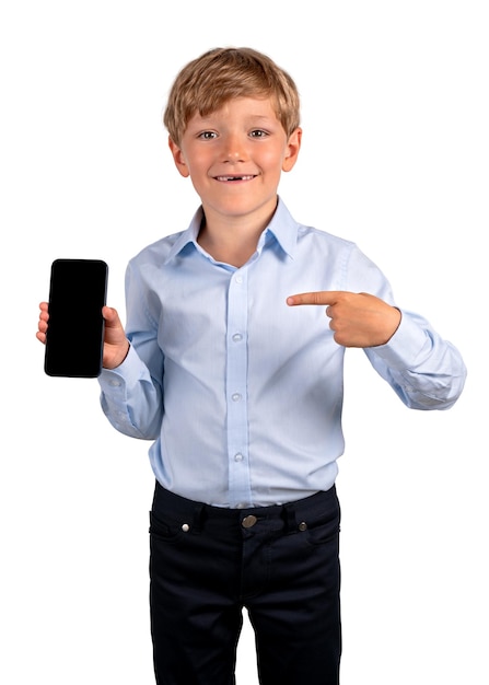 Smiling boy pointing to the smartphone in hand isolated over white background