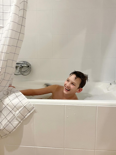 Photo smiling boy taking a bath