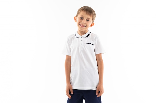 Smiling boy with brown hair and bangs on white with copy space