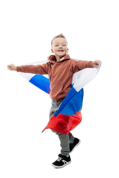 Smiling boy with the Russian flag. Independence Day, Constitution Day and Patriotism. Full height. Isolated on white background. Vertical.