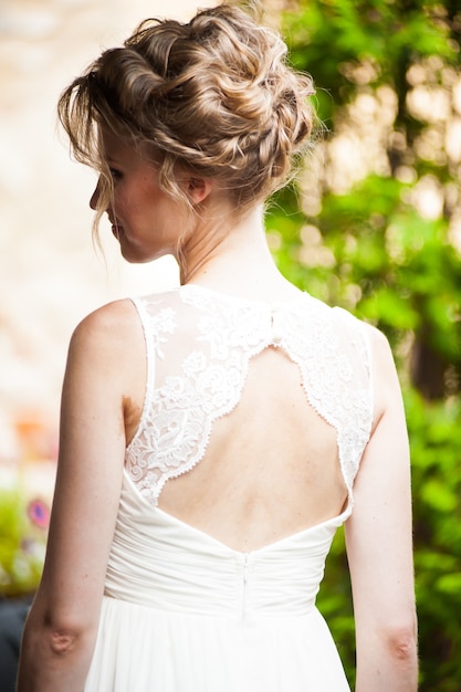 Smiling bride holding big wedding bouquet