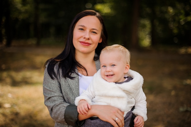 Smiling brunette mother with a cute little daughter