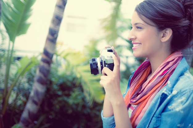 Smiling brunette taking a photo 