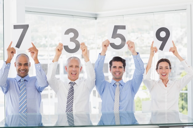 Smiling business team showing paper with rating