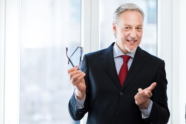 Smiling businessman in his office