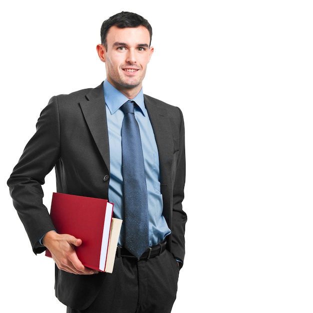 Smiling businessman holding books on white background