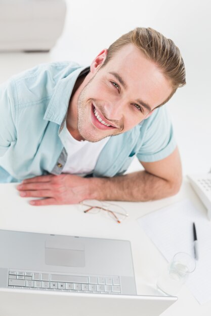 Smiling businessman using laptop 